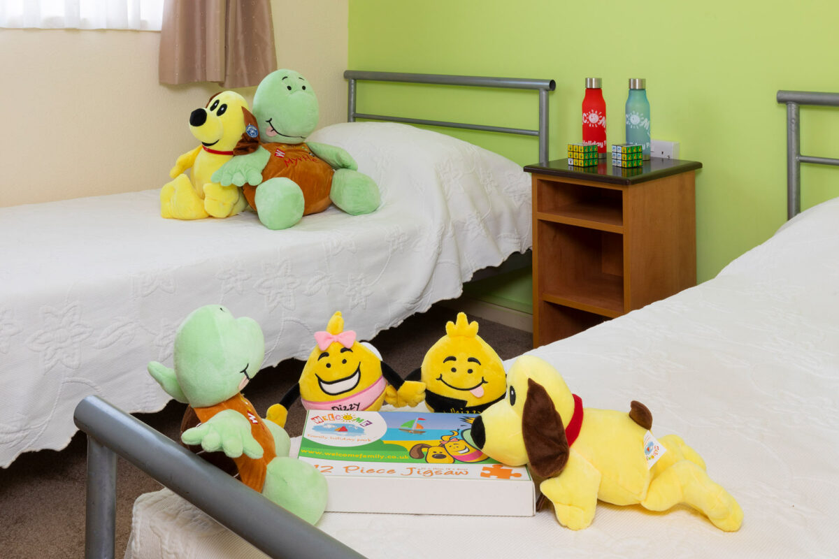 Kids having fun in the twin bedroom in the Sandsurfer bungalow at Welcome Family Holiday Park