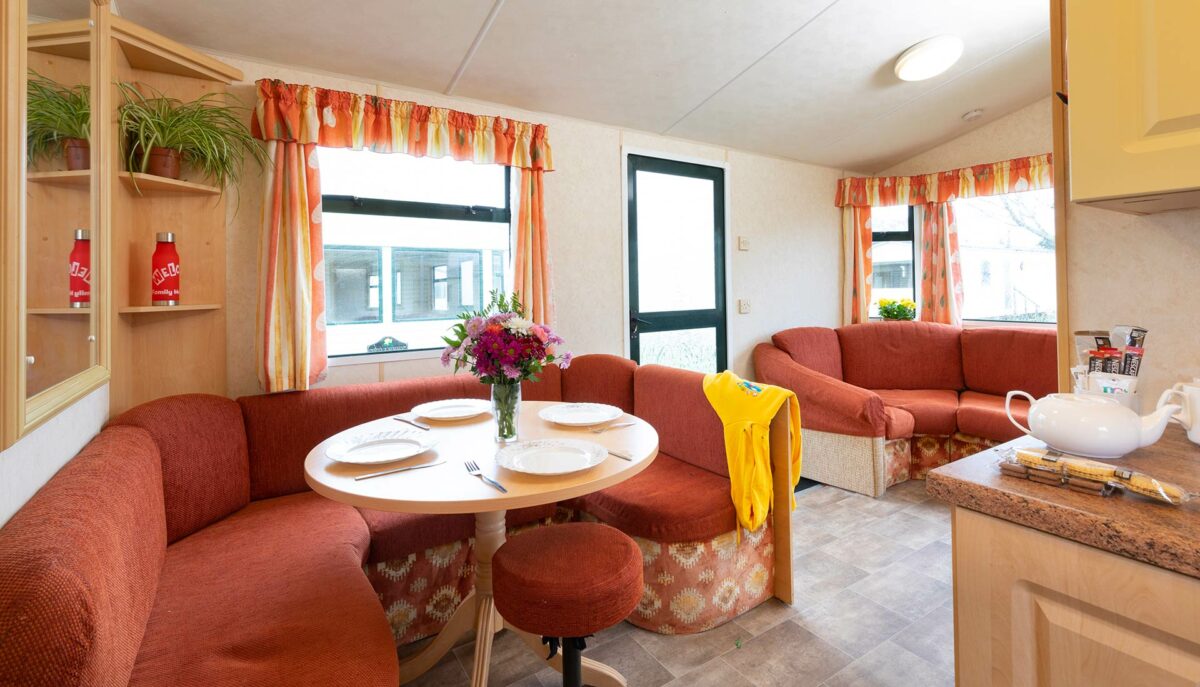 Dining table all set in the Sunset caravan at the Welcome Family Holiday Park