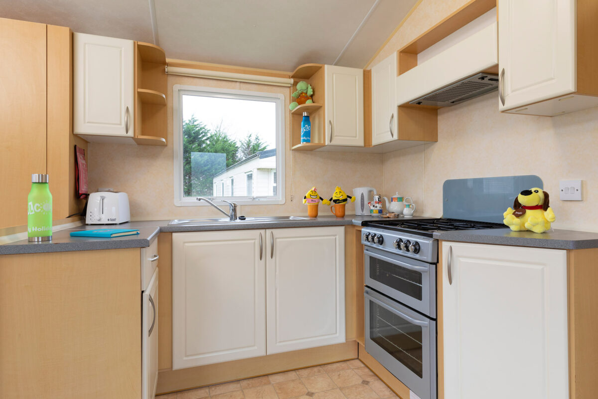 Clean and bright kitchen area in the Sunrise caravan at Welcome Family Holiday Park