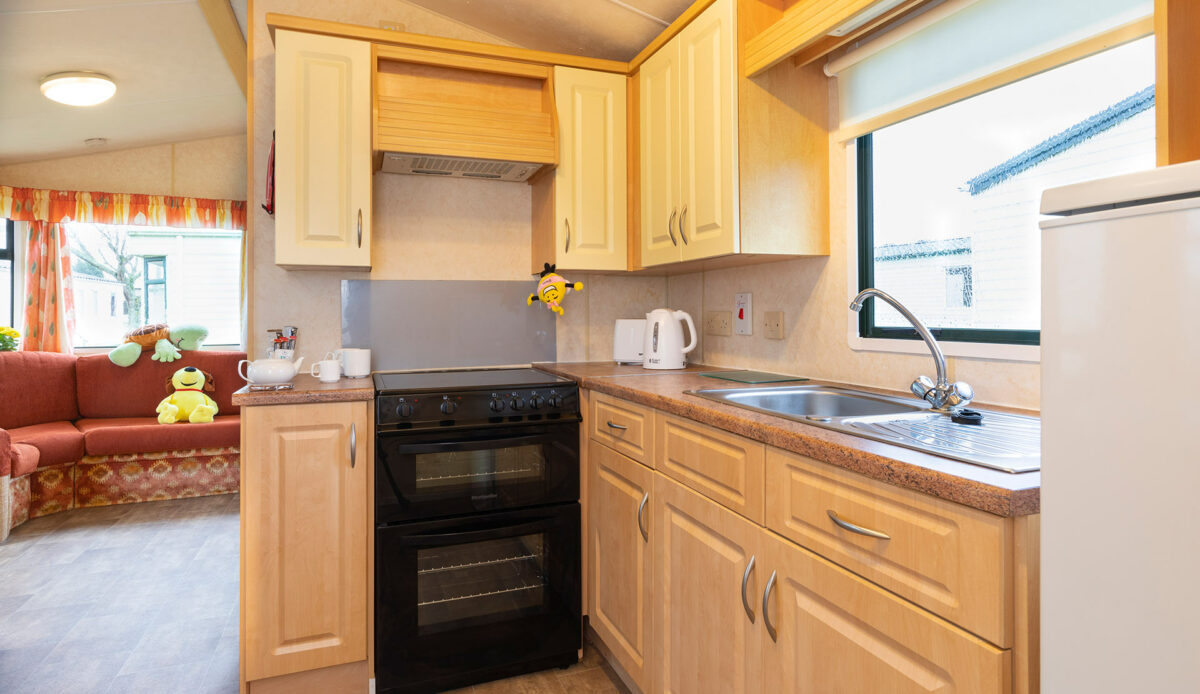 Kitchen area all clean in the Sunset caravan at the Welcome Family Holiday Park