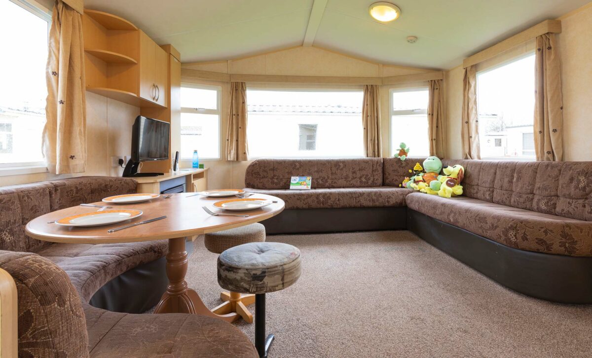 Light and bright living area in the Sunrise caravan at Welcome Family Holiday Park