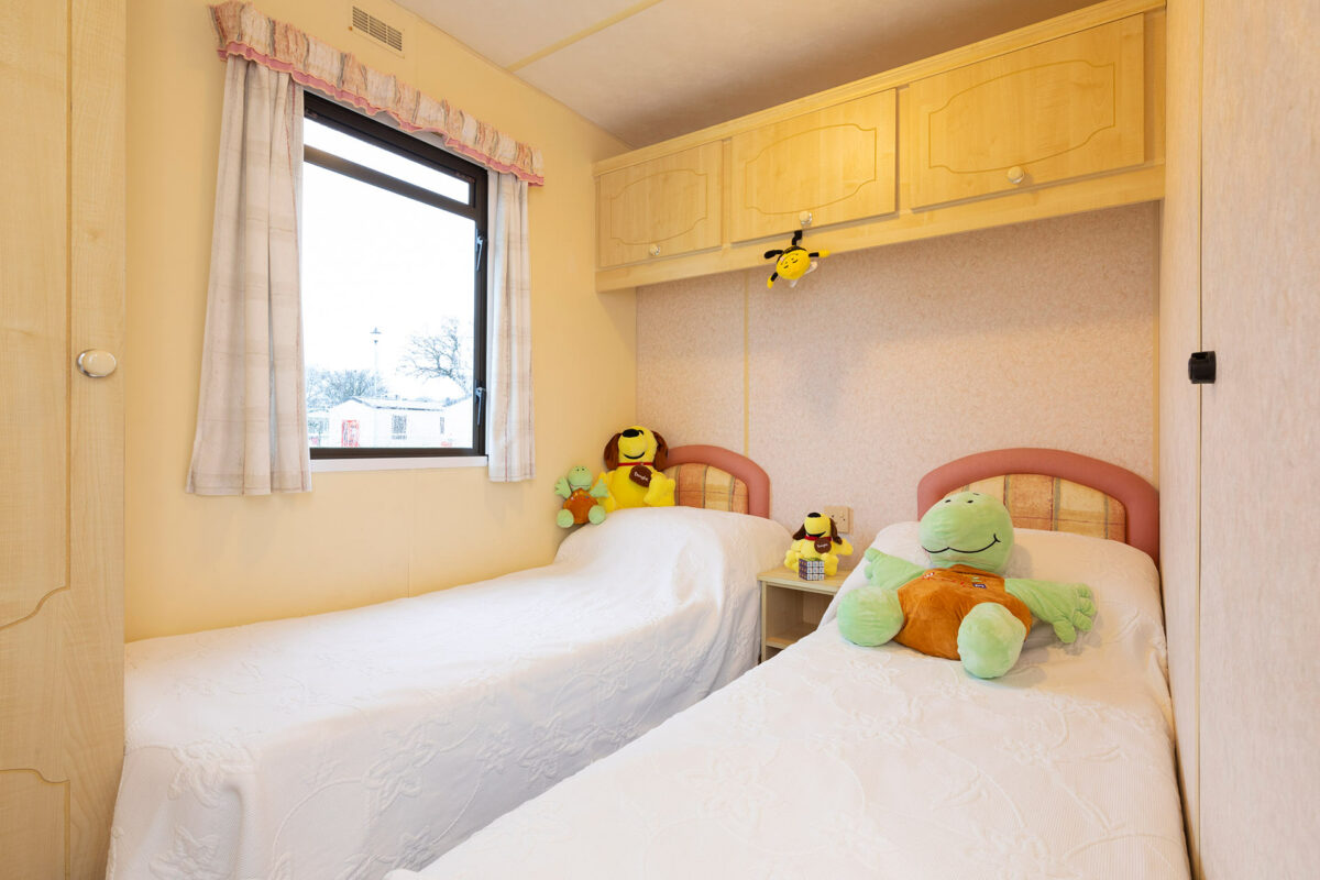 Cute and cosy twin bedroom in the Sunrise caravan at Welcome Family Holiday Park