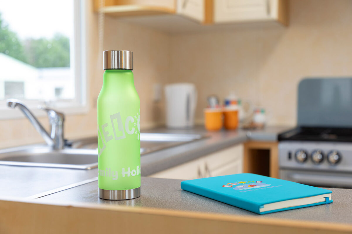 Water bottle and notebook in the Sunrise caravan at Welcome Family Holiday Park