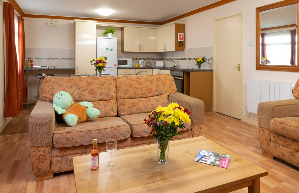 View of the lounge and kitchen in Starsurfer bungalow at Welcome Family Holiday Park