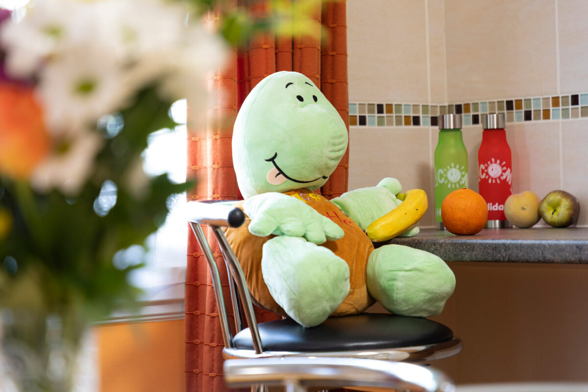 Myrtle with a bowl of fruit in Starsurfer bungalow at Welcome Family Holiday Park