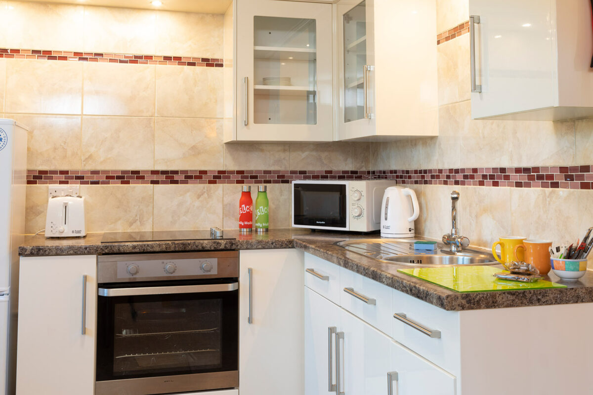 Clean and bright kitchen in the Wavesurfer bungalow at Welcome Family Holiday Park