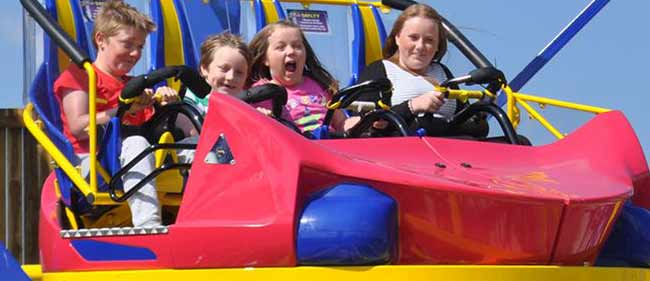 http://Kids%20on%20a%20ride%20at%20Crealy%20Adventure%20Park%20in%20Exeter