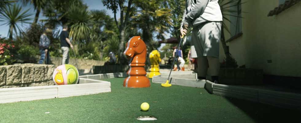 Boy playing Crazy Golf at Welcome Family Holiday Park, Dawlish Warren