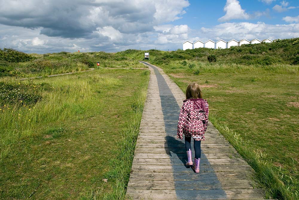 Girl walking at Dawlish Warren nature Reserve