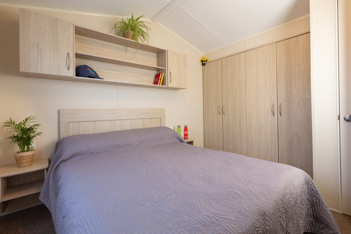 Clean and bright master bedroom in the Casario premier caravan at Welcome Family Holiday Park