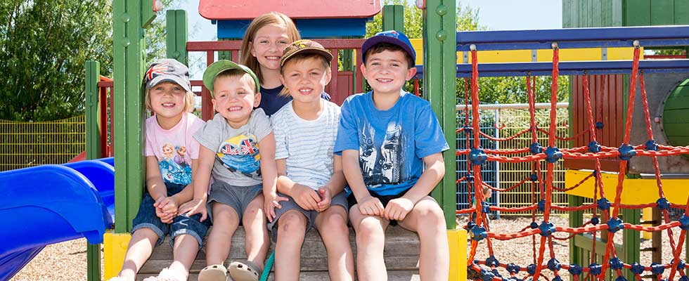 Kids sitting on climbing frame at Welcome Family Holiday Park