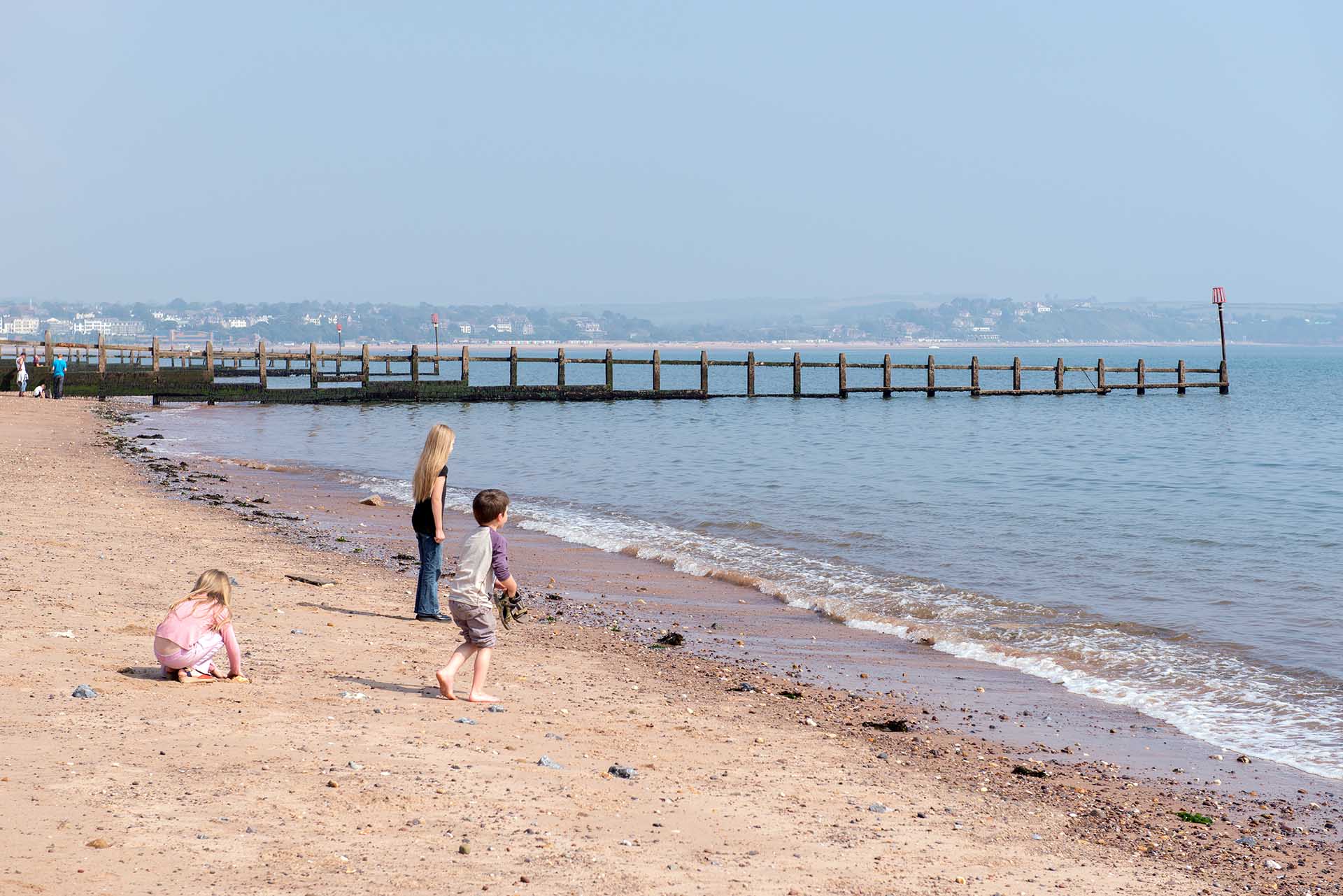 Children playing on Dawlish Warren beach next to shore