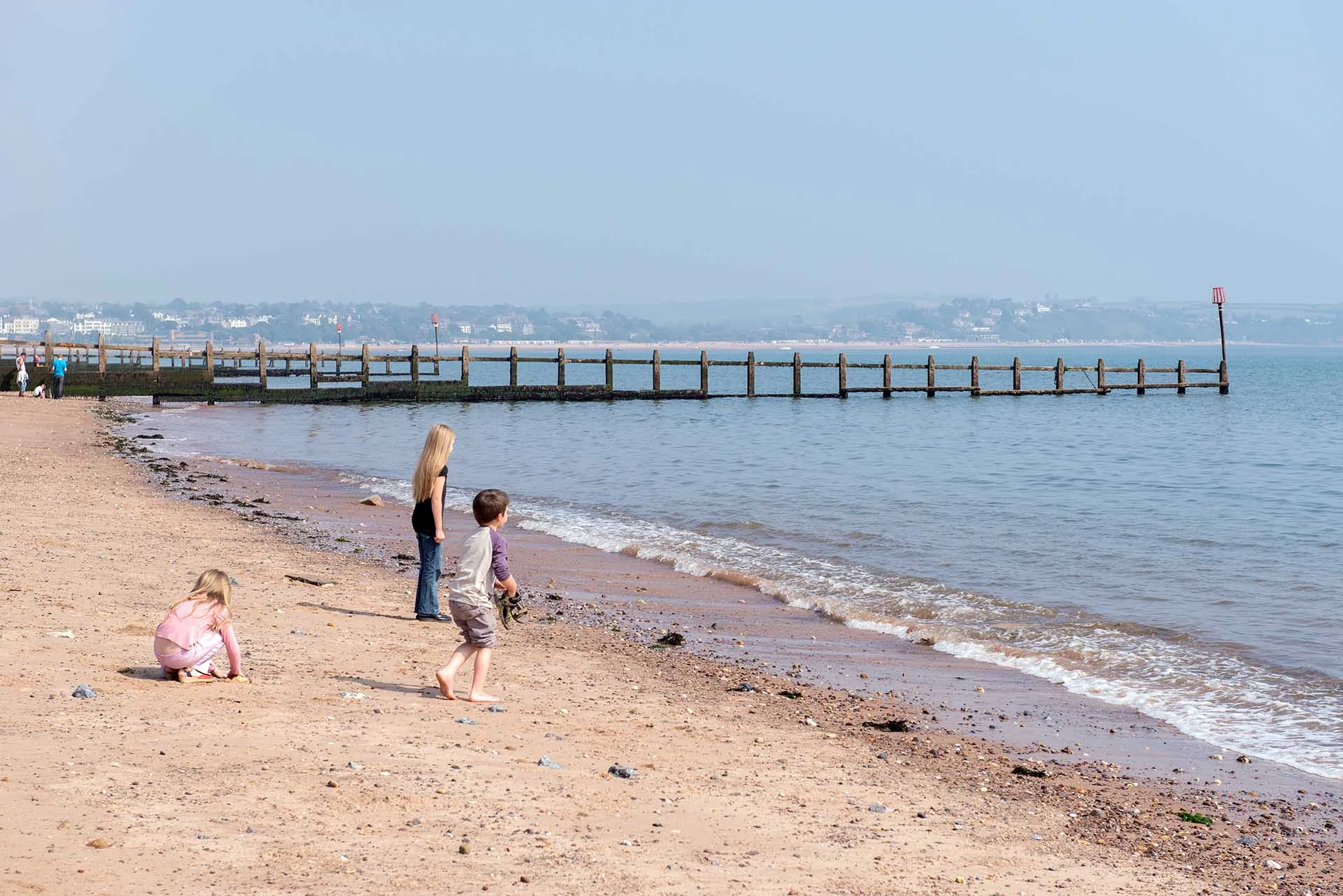 Children playing on Dawlish Warren beach next to shore