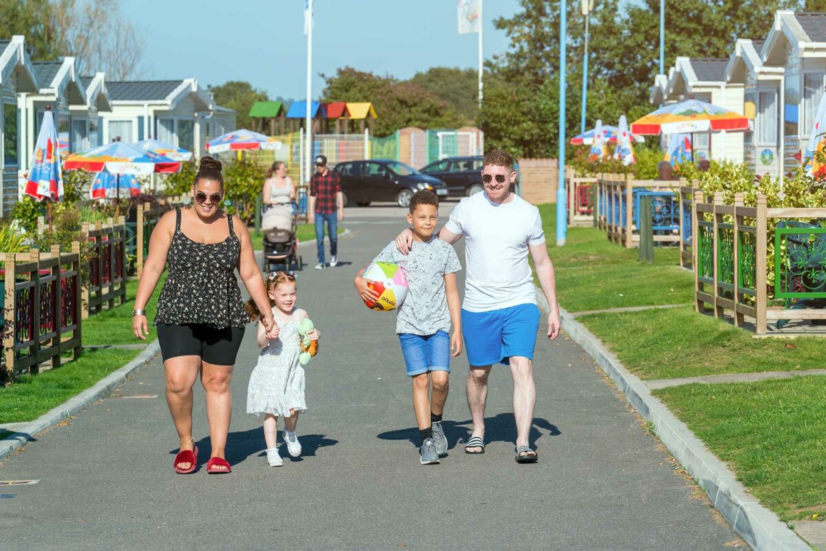 Family walking around Welcome Family Holiday Park in sunshine