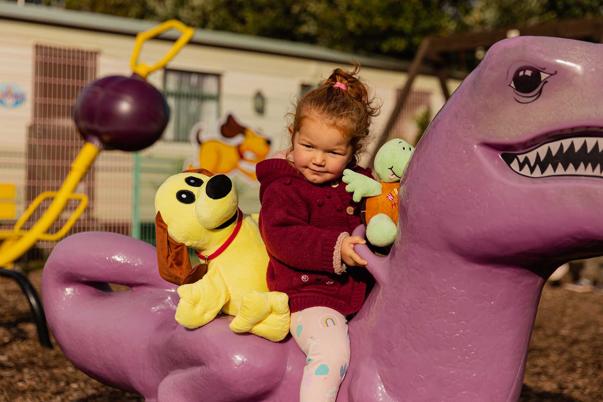 Child riding on a dinosaur ride in Welcome playground