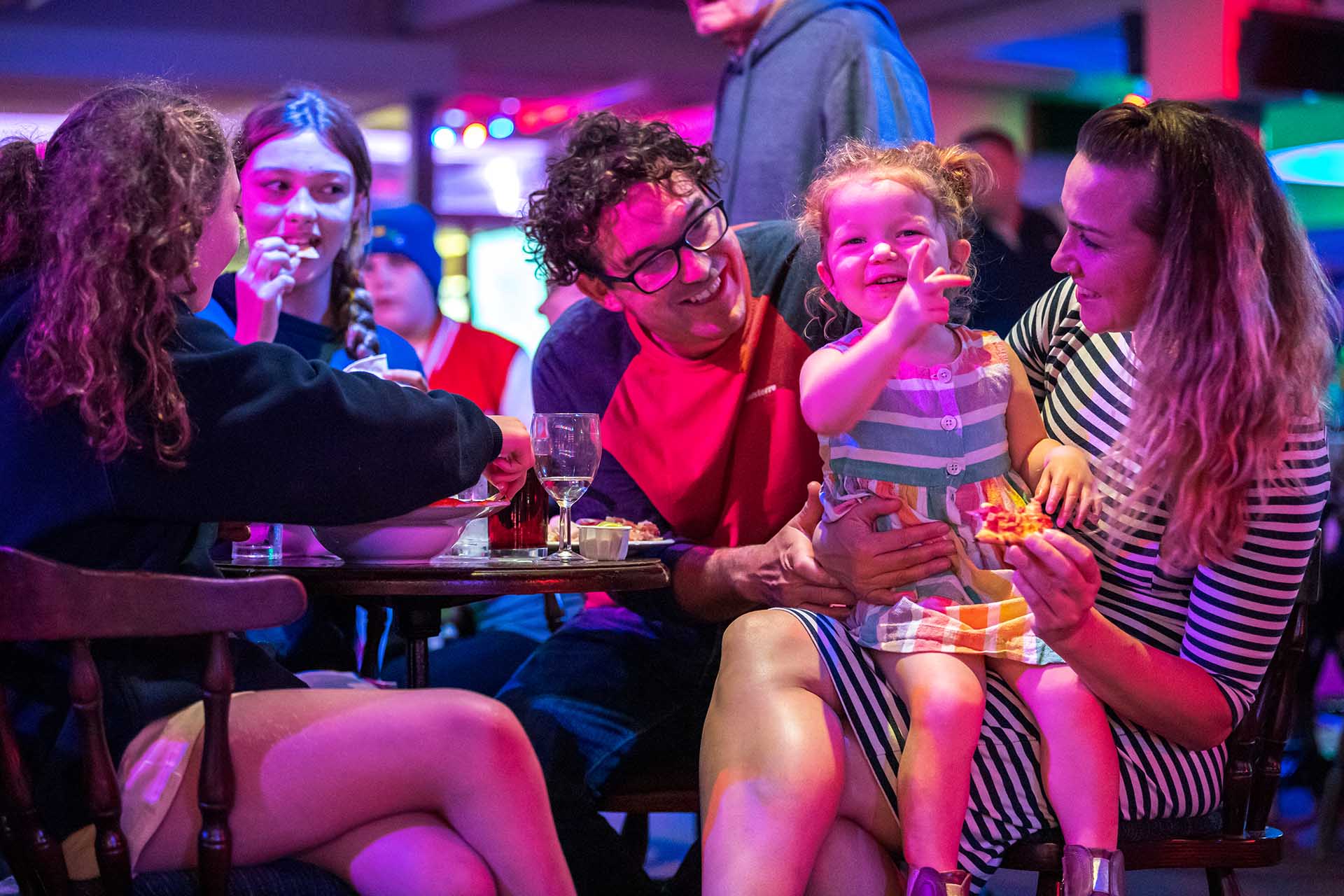 Family enjoying dinner and entertainment at Welcome