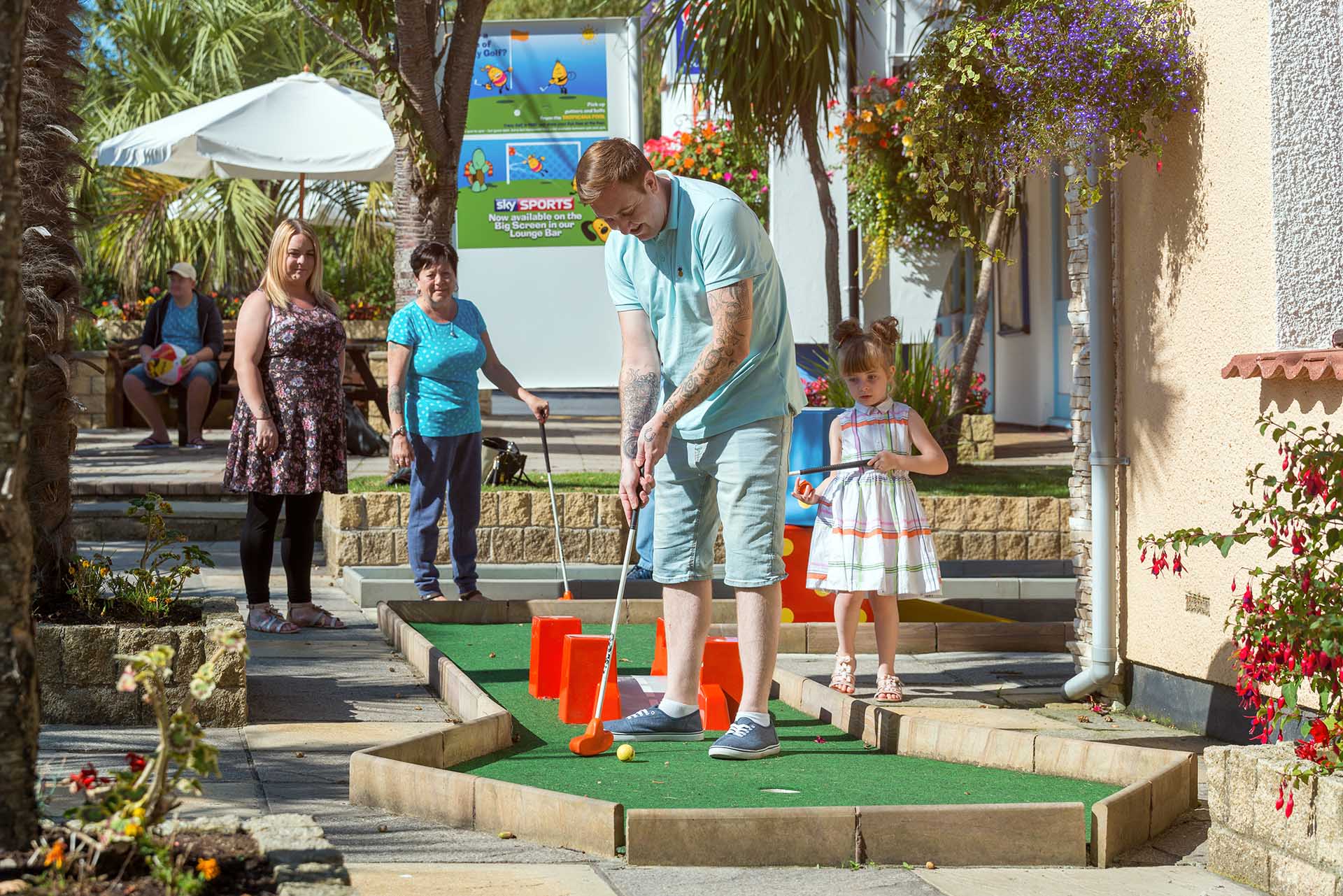 Family playing Welcome crazy golf