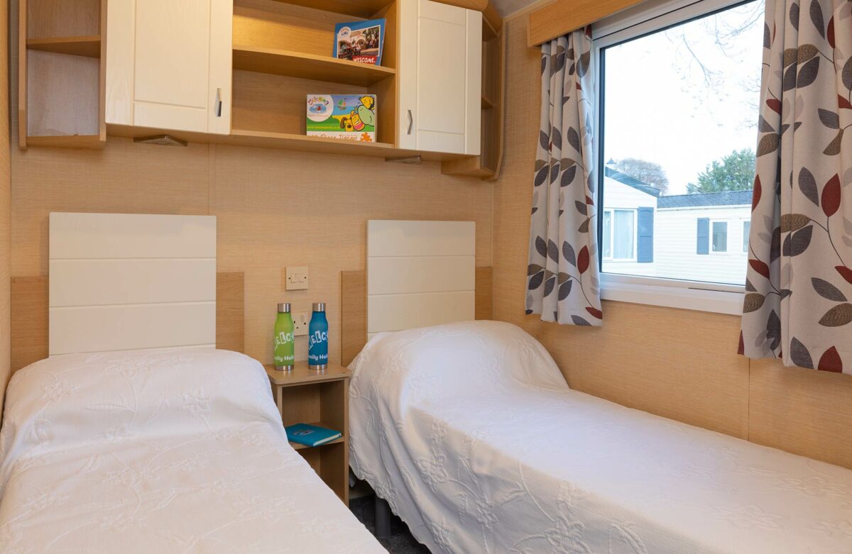 Clean and crisp twin bedroom in the Silver Reef at Welcome Family Holiday Park